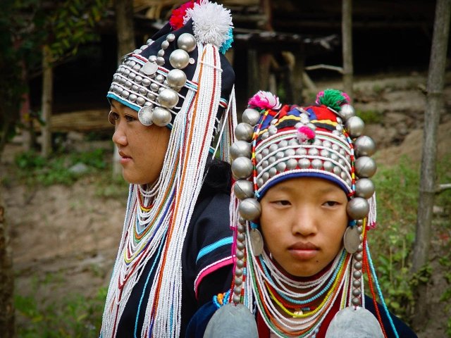 akha girls wearing traditional headpieces